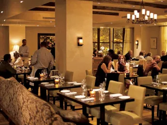 Ambient lighting and comfy chairs star in the second-floor dining room. 