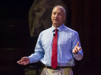 Dean Michael D. Smith delivers his campaign address in Sanders Theatre.