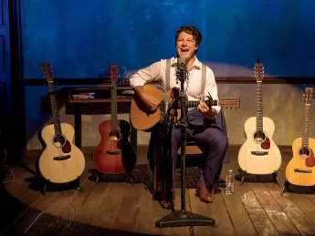 Benjamin Scheuer playing one of the six instruments he uses in the course of his one-man musical, The Lion