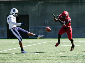  Harvard freshman Khalil Dawsey blocks the punt of Howard's Isaiah Moore.