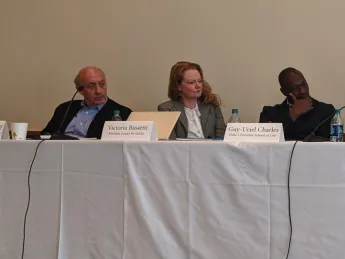 Photo of three speakers seated at a table