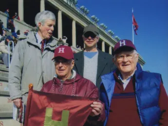 Paul Lee (left) holds the Little Red Flag replica in 2012. Also shown (clockwise from top left) are Spencer Ervin, Jeffrey Lee, and Stephen Goodhue. 