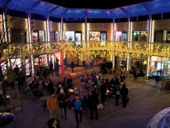 Bow Street’s festive courtyard lit up at night.