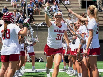 The Harvard women’s lacrosse team takes the field.