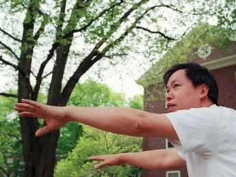 Master Yon Lee extends his hands in a tai chi pose.