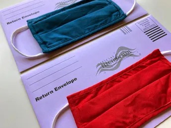 photograph of two election mail envelopes with face masks