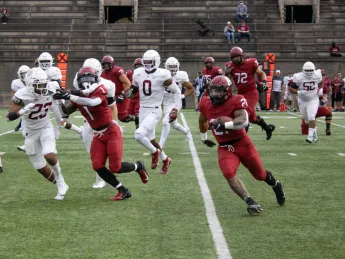 Running back Aidan Borguet runs up field with ball in hand