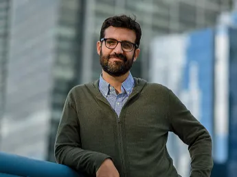 Bruno Carvalho stands in front of a city background