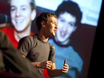 Mark Zuckerberg (backed by an image of himself when <i>really</i> young) meets with computer-science students at Farkas Hall.