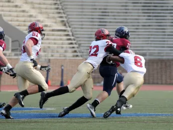 Linebacker Jacob Lindsey (51) trails the play as safety Reynaldo Kirton (22) and cornerback Brian Owusu (6) bring down Penn quarterback Billy Ragone. Ragone rushed for 95 yards and a touchdown, passing for two more Quaker scores in a 30-21 upset.