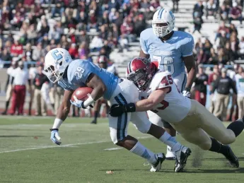 Strong defensive play held Columbia’s ground game to a net 49 yards rushing. Above, senior linebacker Matt Martindale (45) hauls down tailback Alan Watson. Martindale finished the game with five tackles and a quarterback sack.