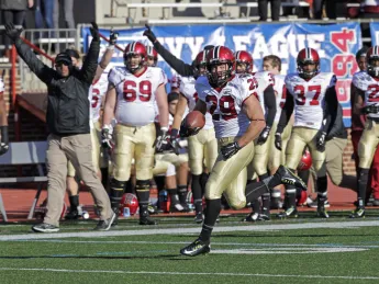 With nary a Quaker in sight and the Harvard bench cheering him on, Paul Stanton Jr. ’16 cruised goalward on his 75-yard, second-period touchdown dash. The score, already Stanton’s second of the game, gave the Crimson a 14-10 lead.