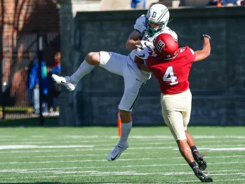 Harvard defensive back Max Jones knocks a ball out of the hands of Dartmouth wide receiver Drew Estrada