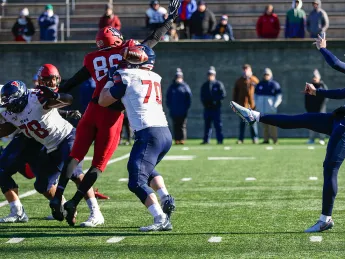 Penn's kicker, Jake Haggard, punts the football. 