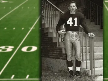 Carroll Lowenstein standing at the base of staircase