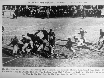 A ball flies through the air off the foot of Vic Kennard.