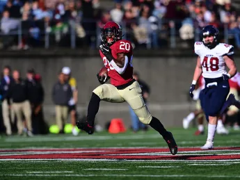 Aaron Shampklin struts down the field with ball in hand.