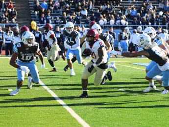 Running back Aidan Borguet runs up field through Columbia defenders.