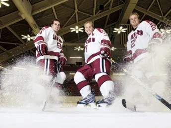 Hard-skating brothers Danny, Alex, and Michael Biega (left to right) spray ice chips at Bright Hockey Center.