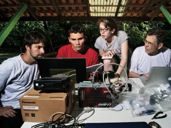 Bernardo Flores, Rafael  Tapajós, and Hannah Horowitz ’11 learn how to analyze data  gathered from a weather balloon under the supervision of  Professor Steven Wofsy