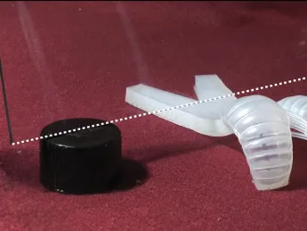 The soft robot can wiggle its way underneath a pane of glass just three-quarters of an inch above the surface.