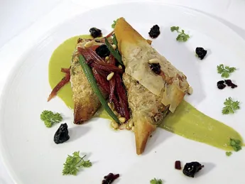 From the menu: phyllo triangles filled with caramelized onions, chard, and tofu, in a sorrel cream sauce
