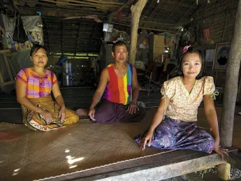 Daw Than Than Sein, U Win Hlaing, and daughter Win Win Thu at their home in the Ayeyarwaddy River Delta village of Wakouktaw; Proximity Designs&rsquo; irrigation equipment has helped them expand their farm and boost their income significantly. 