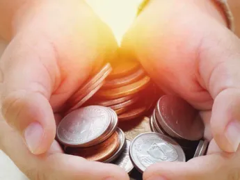 Hands holding coins
