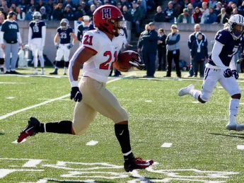 Photograph: With Yale’s Melvin Rouse II in vain pursuit, Harvard’s Aidan Borguet heads for the goal line. 