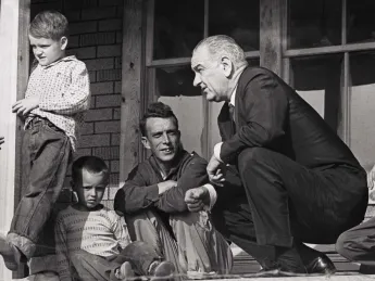 Historic photograph of President Lyndon Johnson meeting with impoverished Fletcher family in Kentucky in 1964