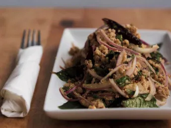 An appetizer of ground pork with onions and basil