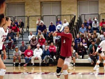 Harvard volleyball player Sandra Zeng setting a ball during a game