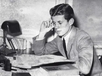 Archival photograph of John F. Kennedy as an undergraduate, circa 1939, studying papers