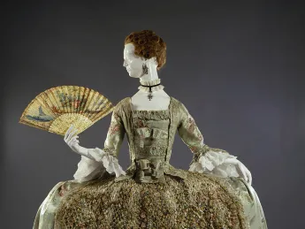 Ornate eighteenth-century dress with wide hooped skirt