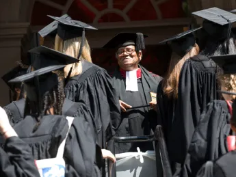 The Reverend Peter J. Gomes with graduating seniors outside the Memorial Church