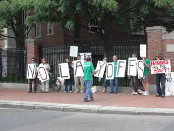 Union members from AFSCME protest potential layoffs at Harvard on Commencement day.