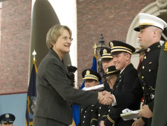 President Drew Faust presented each newly commissioned officer with a copy of <i>Just and Unjust Wars</i> by Michael Walzer.