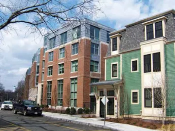 A new wood-frame building on Cowperthwaite Street softens the profile of a six-story brick-and-glass apartment complex.