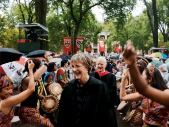 The Harvard College Pan-African Dance and Music Ensemble gives Drew Gilpin Faust, attired in Harvard’s presidential gown, a raucous welcome. President emeritus Derek Bok and James R. Houghton, Senior Fellow of the Harvard Corporation, follow her in the procession into Tercentenary Theatre.