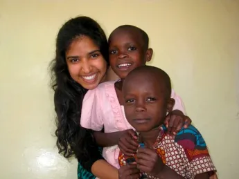 Rashmi Jasrasaria ’10 investigated several topics, including some research that involved visiting partner organizations of the Arusha Project, the nongovernmental organization (NGO) that was hosting her as a researcher. Here, she is shown with two children who attend the Baraa Orphanage and Nursery School, whose directors are both HIV-positive.
