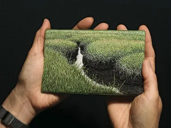 The artist holds <i>Summer Salt Marsh</i> (2008).