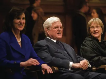Senator Edward M. Kennedy, his wife, Victoria Reggie Kennedy, and President Drew Faust. Members of the Kuumba Singers appear in the rear.