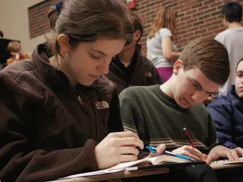 Sophomore Meryl Federman and senior Adam N. Hallowell keep themselves busy during a break in the action at Brown University&rsquo;s early fall tournament.