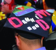 close-up of graduating dental student (Bordador) -- (his cap reads, 'Damn i'M gooD,' with the D.M.D. in red)