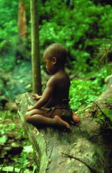 An Efe child wearing a traditional bark-cloth garment.