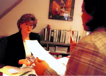 In her office, amid mounds of paperwork.