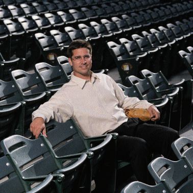 Musselman sitting amidst empty rows of stadium seats