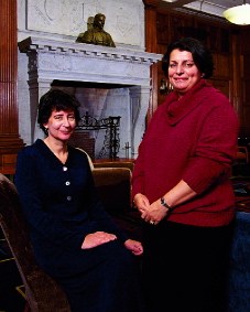 Elisa New and Inge-Lise Ameer pose in front of fireplace