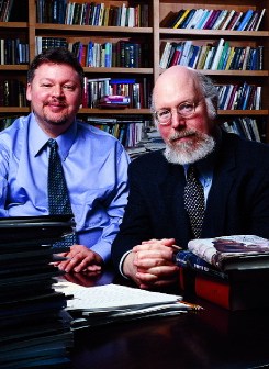 Shawn Harriman and Stephen Kosslyn pose in front of bookshelves