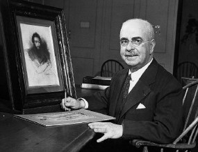 Paul J. Sachs posing at his writing desk